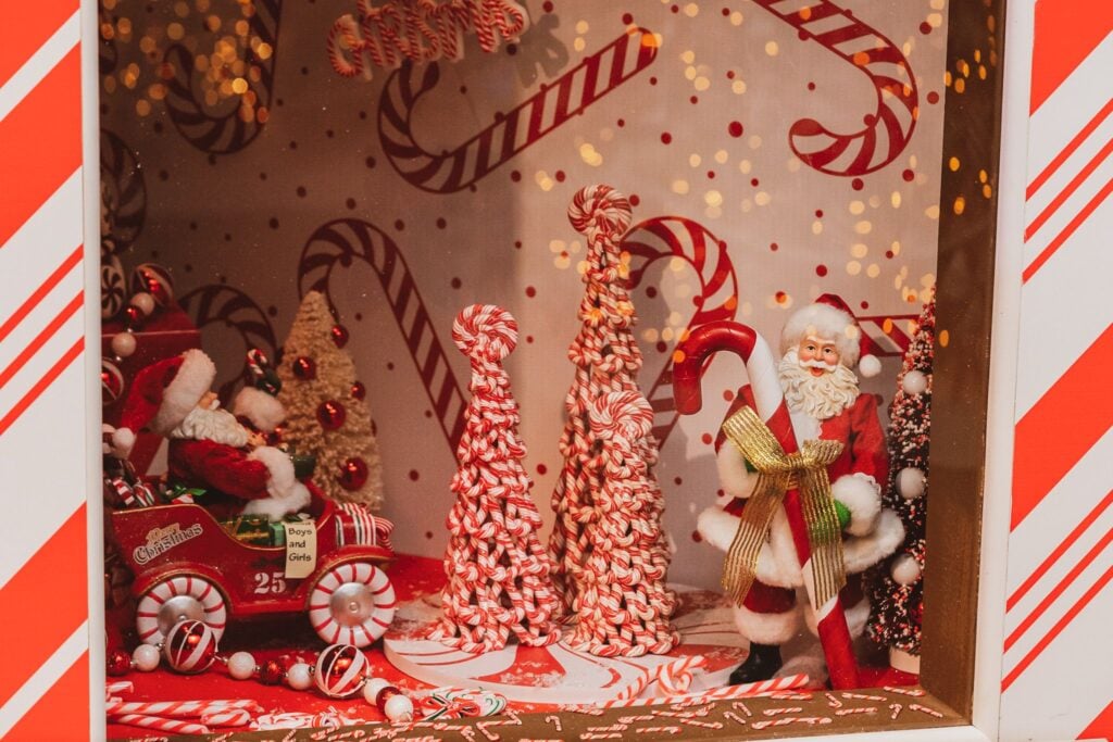 Candy cane window display with Santa and peppermint trees