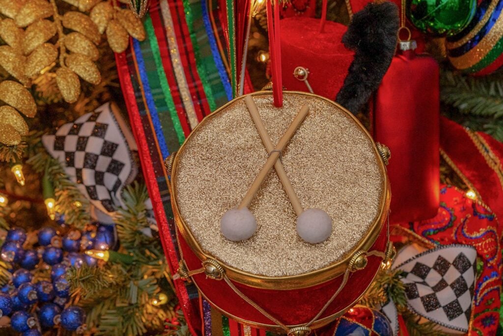Gold drum ornament on a decorated Christmas tree