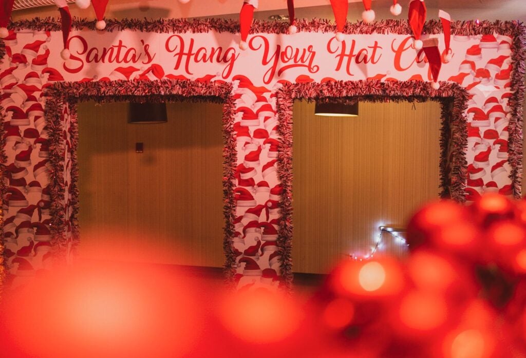 Santa's Hang Your Hat Cafe arch decorated in red tinsel