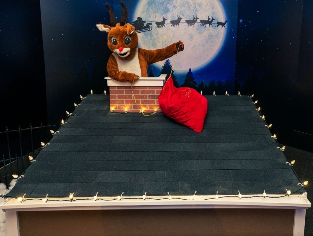 Rudolph on a moonlit rooftop photo set at ChristmasLand