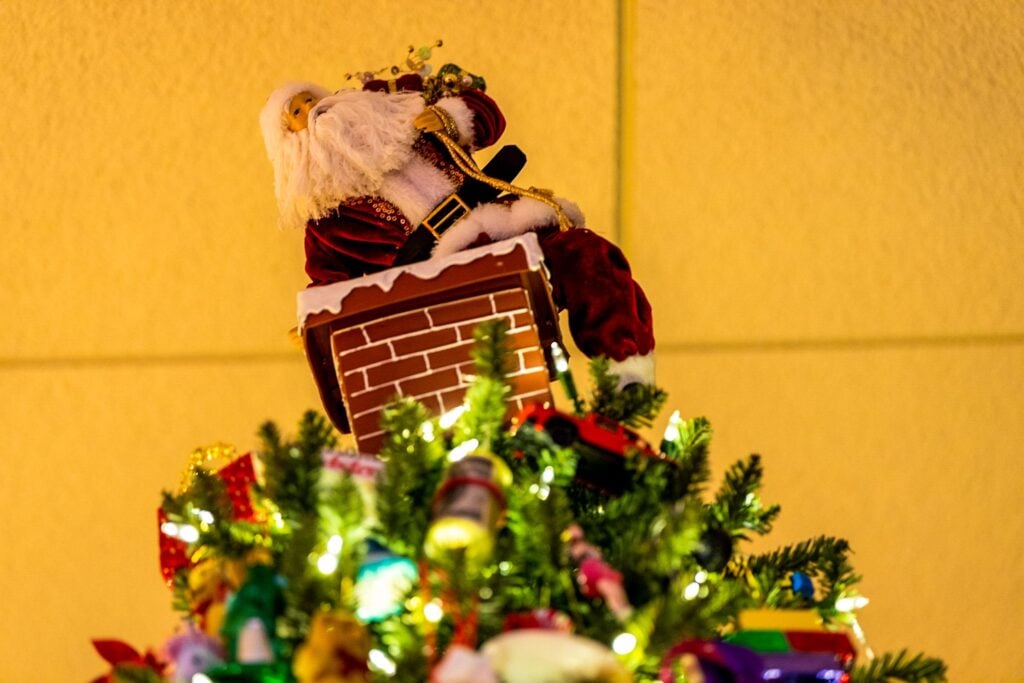 Santa on a chimney topping a Christmas tree at ChristmasLand