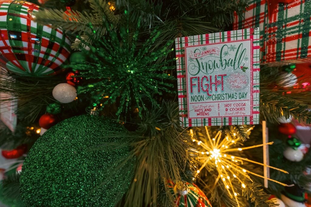 Snowball fight sign tucked in a decorated Christmas tree at ChristmasLand