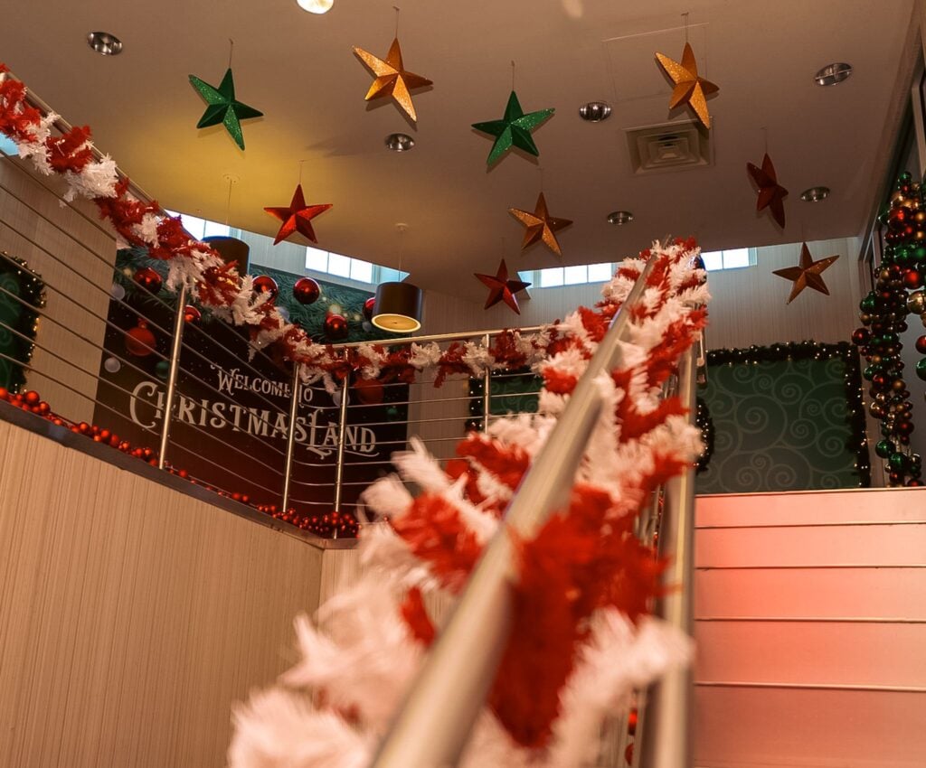 Garland-wrapped staircase up to the ChristmasLand entrance in Deer Park NY